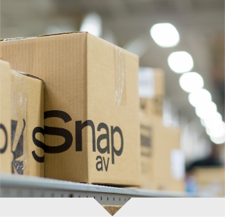 SnapAV boxes sitting on a conveyer belt